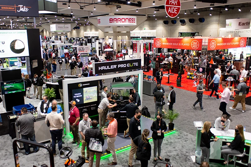 Attendees watching a live product demonstration on the trade show floor